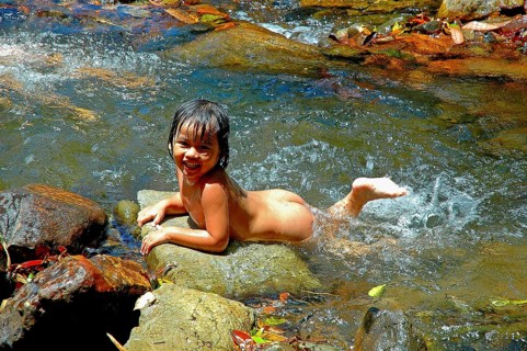 Little naked girl swimming naked in the creek, Thailand