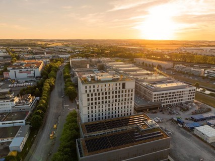 Urban industrial area with roads and buildings at sunset, construction site of the new airfield
