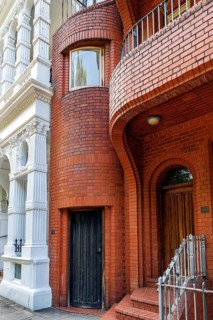 Secret London, Close view of the curved red brick facade of London's smallest house at 10 Hyde Park
