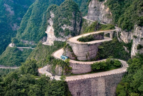 Heaven Linking Avenue on Tianmen Mountain, China, A winding road with sharp turns amidst lush green