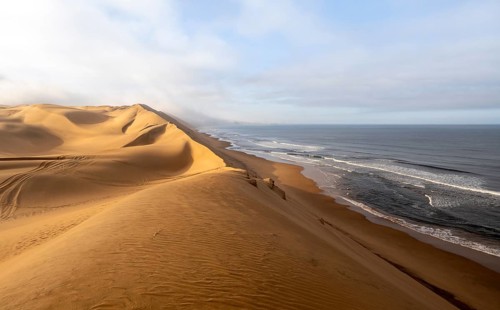 Sand dunes and sea, Atlantic coast and sandy desert with sea of dunes, Sandwich Harbour, Namib