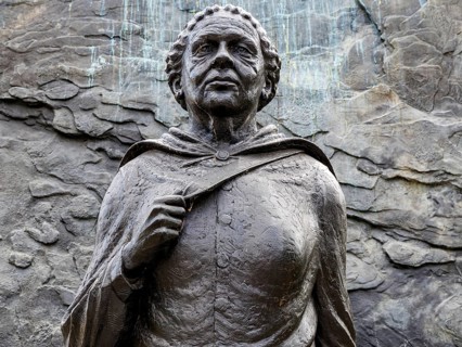 A close view captures the weathered bronze face and cloaked shoulders of the Mary Seacole statue at