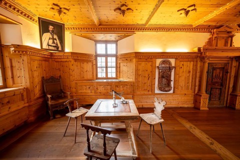 Reconstructed princely room with decorative wood paneling and furniture, Hohenwerfen Fortress,