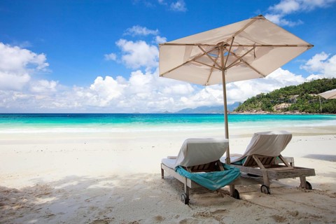 Two sun loungers and an sunshade on La Digue beach, Seychelles, La Digue, Indian Ocean, Seychelles