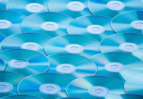 A table full of CD-ROM and DVD, pirated copy, studio recording, Austria
