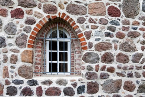 Old stone wall made of erratics rocks and bricks, Church of St. Urbanus, Dorum, Lower Saxony,
