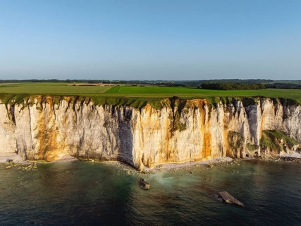 Aerial view of rugged chalk cliffs in the evening sun, Étretat, Alabaster Coast, La Côte d'Albâtre,