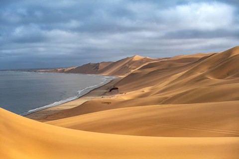 Sand dunes and sea in morning light, Atlantic coast and sandy desert with sea of dunes, Sandwich