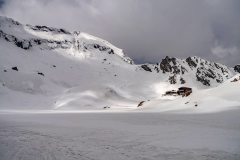 The snowy glacial lake Balea Lake in the Fagaras Mountains, South Carpathians, Transylvania,