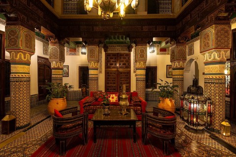 Oriental courtyard with carpet and beautiful furnishings at Hotel Riad Palais Sebhan, former city