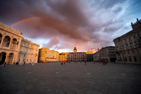 Piazza Unità d'Italia square with town hall and magnificent palazzi in the evening light at sunset