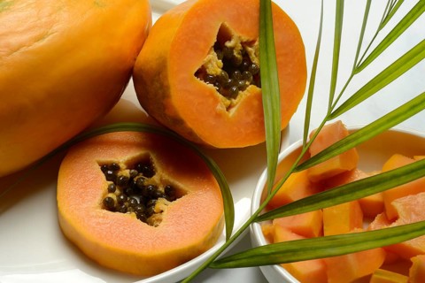 Pawpaw, split fruit in skin, halved and whole fruit, Carica papaya