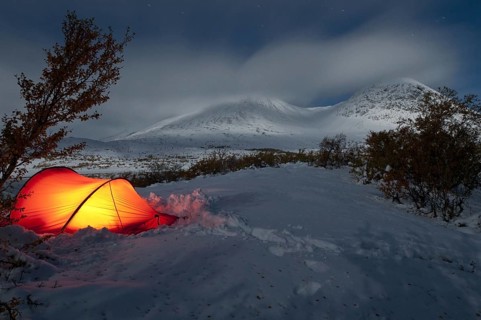 Bivouac, illuminated tent on a bright moonlit night in the Döralen valley, Rondane National Park,