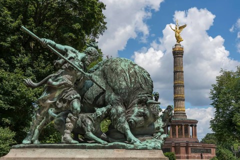 Fasanerieallee and hunting sculpture Old Germanic buffalo hunting in the zoo with a view of the