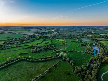 Sunset of Fields and Farms over Horsebridge nad Stockbridge from a drone, Hampshire, England,