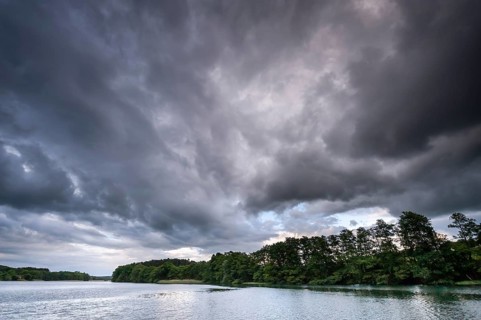 Threatening storm clouds over a lake in Müritz National Park, Feldberg Lake District,