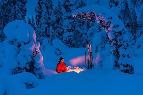 Man around a campfire, Muddus National Park, Laponia World Heritage Site, Norrbotten, Lapland,
