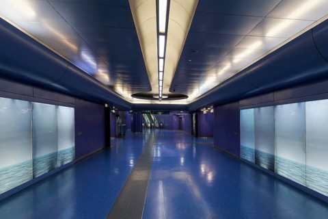 Passage in Toledo metro station, backlit wall with photo of the sea, architect Oscar Tusquets