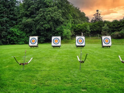 Four targets, archery, bow and arrow shooting, leisure activity, green grass, park, event,