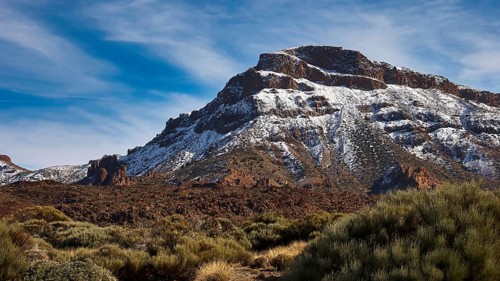 Near Ermita de las Nieves, snowy mountain with rocks under wide blue sky, Teide, Parque Nacional