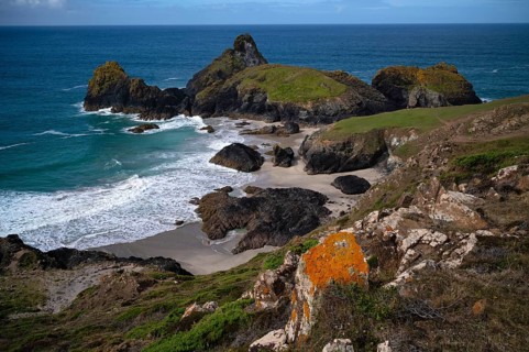 Rocks with lichens against coastal landscape, coast, rock formations, rocks, sandy beach, beach,