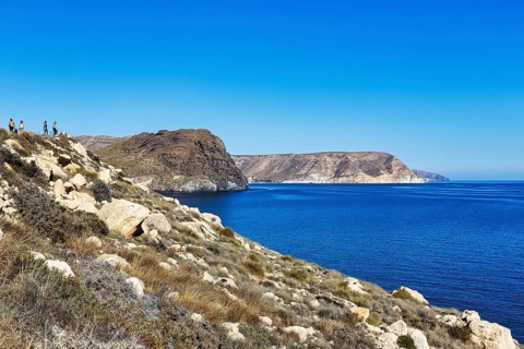 Hikers on rocky coast, Cabo de Gata-Nijar nature park Park, Las Negras, Nijar, Almeria, Andalusia,