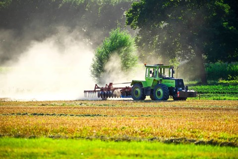 Tractor ploughs a harvested field in a cloud of dust in Kirchwerder, Hamburg, Germany +++ editorial