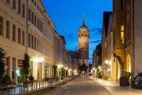 Coswiger Straße in the evening with castle church tower, Luther city Wittenberg, Saxony-Anhalt,
