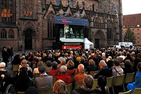 Open-air cinema with spectators in front of St. Sebaldus Church on Open Day, Nuremberg, Middle