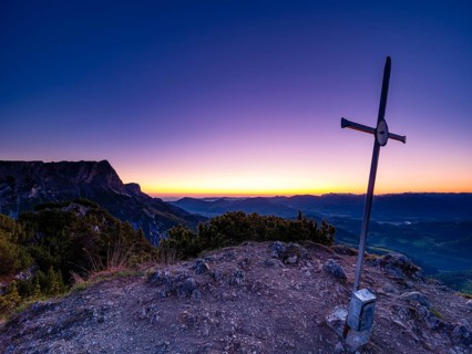 Dawn at the summit cross of Rauhen Kopf, behind the Untersberg, Berchtesgaden Alps, Bischofswiesen,
