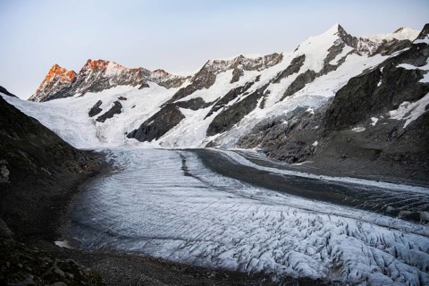 Impressive high-alpine landscape, Finsteraarhorn and Agassizhorn mountain peaks with alpine glow at
