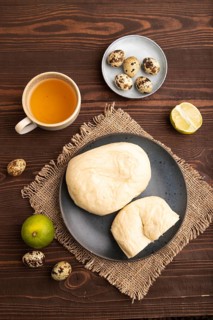 Vietnamese steamed buns Banh bao on brown wooden background and linen textile. top view, flat lay,
