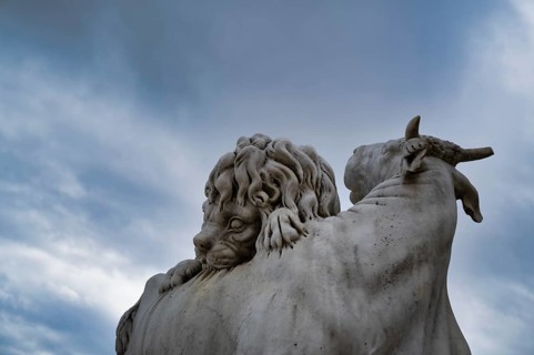 Lion attacks a bull, historic animal sculpture made of Carrara marble, Wilhelma,