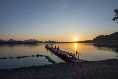 People enjoy sunset at Hopfensee near Füssen, Ostallgäu, Allgäu, Upper Swabia, Swabia, Bavaria,