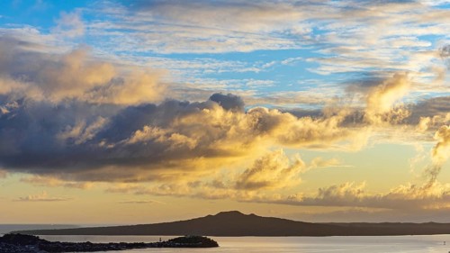 Sunrise clouds above North Head and Rangitoto Island volcano, seen from Mount Eden, Auckland, New