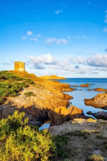 An old tower at the coast at Marinedda at sunset, Sardinia, Italy