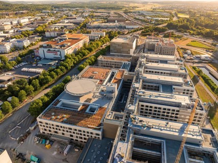 Extensive industrial buildings and urban environment with detailed roof structures, construction
