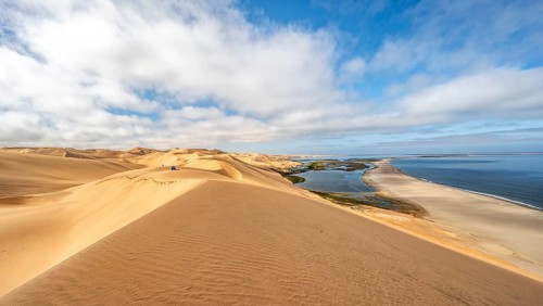 Sand dunes and sea, Atlantic coast and sandy desert with sea of dunes, view of lagoon at Sandwich