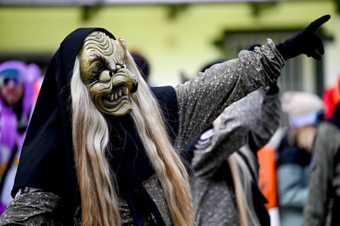 Member of a fools' guild in traditional Haes, fools' clothes, during the carnival procession in