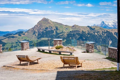 Viewing platform with benches, offering panoramic views of hilly landscape, Hahnenkamm, Kitzbühel,