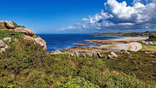 Panorama of a rocky coast with clear blue sky and calm sea, The coastal landscape near Cleder in