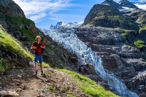 Mountaineers in front of picturesque high alpine mountain landscape with Lower Arctic Sea glacier,