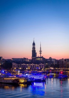 Aerial view of Landungsbrücken at sunrise on the Elbe with St Michael's Church (Michel) and