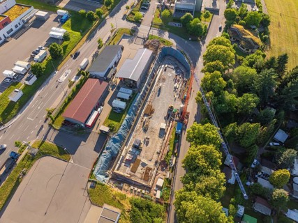Aerial view of an active construction site with construction work in an industrial environment