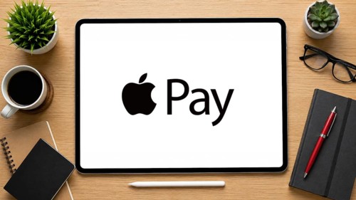 In this photo illustration, an iPad displays the Apple pay logo on a minimalist wooden office desk,