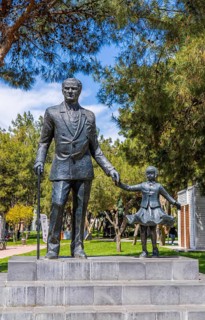 Antalya, Turkiye - April 14, 2025: Statue of Mustafa Kemal Ataturk holding childs hand in public