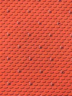 The roof of an old building (church) has just been renovated. New roof tiles on a house, Austria