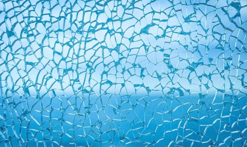 Frozen abstract texture resembling winter frost or cracked ice surface. Delicate crystalline