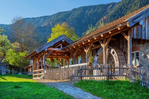 Historic Schleifmühle, water mill, in the village in spring, Ohlstadt, Loisach Valley, The Blue
