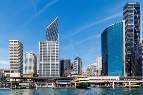 Tall skyscrapers of the CBD rise above the Circular Quay Ferry Terminal, Sydney, Australia